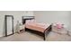 Bedroom features a bed with pink bedding and a decorative headboard, accented by unique decor at 4644 S Kipling Cir, Littleton, CO 80123