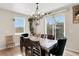 Bright dining room with modern chandelier and sliding glass doors to the backyard at 4644 S Kipling Cir, Littleton, CO 80123