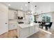 Bright kitchen features modern appliances, a spacious island, and dining area at 4644 S Kipling Cir, Littleton, CO 80123