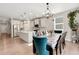 Open-concept kitchen with stainless steel appliances and a large center island at 4644 S Kipling Cir, Littleton, CO 80123