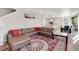 Spacious living room featuring a leather sectional and adjacent dining area at 4644 S Kipling Cir, Littleton, CO 80123
