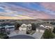 Stunning aerial view of a well-manicured suburban home and neighborhood with a three car garage at 7360 Almandine Ct, Castle Rock, CO 80108