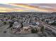 Expansive aerial view showcasing a charming neighborhood with well-maintained homes, mature trees, and scenic mountain views at 7360 Almandine Ct, Castle Rock, CO 80108