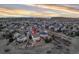 Beautiful aerial view of a suburban home with a large deck, landscaped yard and mountain views at sunset at 7360 Almandine Ct, Castle Rock, CO 80108