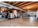 Unfinished basement with exposed ceiling beams and concrete walls, offering potential for customization at 7360 Almandine Ct, Castle Rock, CO 80108