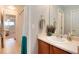 Bright bathroom features a single sink vanity and tub with shower at 7360 Almandine Ct, Castle Rock, CO 80108