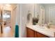 Cozy bathroom with a single vanity, shower-tub combo, and wood-look flooring at 7360 Almandine Ct, Castle Rock, CO 80108