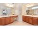 Bright bathroom with dual sinks, vanity area, and walk-in shower at 7360 Almandine Ct, Castle Rock, CO 80108