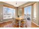 Sunlit dining area with a wooden table, large windows, and access to the outdoor patio at 7360 Almandine Ct, Castle Rock, CO 80108