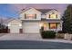 Charming two-story home featuring a three-car garage, manicured lawn and covered porch with white trim at 7360 Almandine Ct, Castle Rock, CO 80108