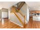 Welcoming foyer with hardwood floors, carpeted stairs and entry to the kitchen at 7360 Almandine Ct, Castle Rock, CO 80108