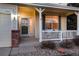 Charming front porch with stone accents, a decorative wreath, and cozy seating, creating a welcoming entrance at 7360 Almandine Ct, Castle Rock, CO 80108