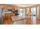 Well-lit kitchen with stainless steel appliances, tile countertops, and breakfast nook near sliding glass door at 7360 Almandine Ct, Castle Rock, CO 80108