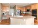 Bright kitchen featuring stainless steel appliances, tile countertops, and an island with a sink at 7360 Almandine Ct, Castle Rock, CO 80108
