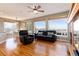 Bright living room featuring hardwood floors, a ceiling fan, and large windows with beautiful views at 7360 Almandine Ct, Castle Rock, CO 80108