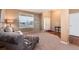 Bright living room featuring plush seating, large window, and carpeted floors at 7360 Almandine Ct, Castle Rock, CO 80108