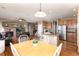 Open-concept living and kitchen area with hardwood floors, stainless steel appliances, and a cozy fireplace at 7360 Almandine Ct, Castle Rock, CO 80108