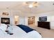 Spacious main bedroom with a fireplace, ceiling fan, TV, and access to the upper floor at 7360 Almandine Ct, Castle Rock, CO 80108