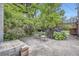 Backyard patio with stone pavers and mature landscaping, providing a serene and private outdoor space at 1640 Pontiac St, Denver, CO 80220