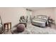 Relaxing bedroom features a decorative rug, a comfortable accent chair and a sliding barn door at 1640 Pontiac St, Denver, CO 80220