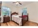 Cozy bedroom with hardwood floors and natural light from two windows at 1640 Pontiac St, Denver, CO 80220