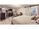 Basement bedroom with a modern fireplace, decorative rug, barn door access and TV at 1640 Pontiac St, Denver, CO 80220