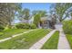Beautifully landscaped front yard with a walkway leading to a charming gray home and detached garage at 1640 Pontiac St, Denver, CO 80220