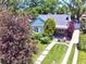 Charming home with a lush front yard, mature trees, and a inviting front porch at 1640 Pontiac St, Denver, CO 80220