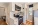 Bright kitchen features stainless steel appliances, white cabinets, and gray subway tile backsplash at 1640 Pontiac St, Denver, CO 80220