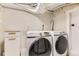 Modern laundry room with white Samsung front load washer and dryer set and built-in storage at 1640 Pontiac St, Denver, CO 80220