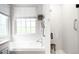 Bright bathroom showcasing a soaking tub, white subway tile shower, and modern fixtures at 3320 Yukon Ct, Wheat Ridge, CO 80033