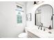 Bright bathroom features a single vanity, framed mirror, and natural light at 3320 Yukon Ct, Wheat Ridge, CO 80033
