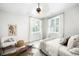 Airy bedroom featuring a ceiling fan, ample natural light, and comfortable seating at 3320 Yukon Ct, Wheat Ridge, CO 80033