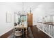 Bright dining room featuring hardwood floors, modern chandelier, and easy access to the staircase at 3320 Yukon Ct, Wheat Ridge, CO 80033