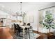 Elegant dining area features modern chandelier, hardwood floors, and backyard views at 3320 Yukon Ct, Wheat Ridge, CO 80033
