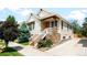 Charming home exterior with stone accents, landscaped front yard, and inviting entrance at 3320 Yukon Ct, Wheat Ridge, CO 80033