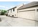 Attached two car garage with white carriage doors, concrete driveway and siding at 3320 Yukon Ct, Wheat Ridge, CO 80033