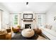 Bright living room features a cozy fireplace, neutral colors, and stylish furnishings at 3320 Yukon Ct, Wheat Ridge, CO 80033