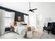 Spacious main bedroom with a feature wall, ceiling fan, and neutral-toned décor at 3320 Yukon Ct, Wheat Ridge, CO 80033