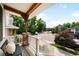 Relaxing front porch offering neighborhood views, stone columns, and comfortable seating at 3320 Yukon Ct, Wheat Ridge, CO 80033