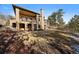 Expansive backyard with manicured landscaping and mature trees, perfect for outdoor activities and relaxation at 214 Equinox Dr, Castle Rock, CO 80108