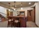 Basement bar with granite countertop, barstool seating, and attractive wood accents at 214 Equinox Dr, Castle Rock, CO 80108