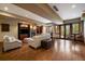 Cozy basement living room features a stone fireplace, built-in shelves, and wood flooring at 214 Equinox Dr, Castle Rock, CO 80108