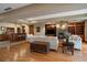 Open-concept basement living area with wet bar, stone fireplace, and built-in shelving at 214 Equinox Dr, Castle Rock, CO 80108