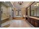 Elegant bathroom featuring a walk-in shower, large tub, and custom vanity with abundant natural light at 214 Equinox Dr, Castle Rock, CO 80108