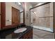 Bathroom with granite countertops, a tiled shower, and a wood-framed mirror at 214 Equinox Dr, Castle Rock, CO 80108
