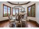 Bright dining room featuring a modern chandelier, fireplace, and large windows with scenic views at 214 Equinox Dr, Castle Rock, CO 80108