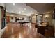 Spacious game room with pool table, shuffleboard, hardwood floors, and a view into the living area at 214 Equinox Dr, Castle Rock, CO 80108