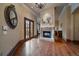 Hallway featuring wood floors, custom fireplace, and French doors at 214 Equinox Dr, Castle Rock, CO 80108