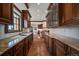 Gourmet kitchen featuring custom cabinets, granite counters, and stainless steel appliances at 214 Equinox Dr, Castle Rock, CO 80108